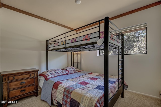 bedroom with light colored carpet and baseboards