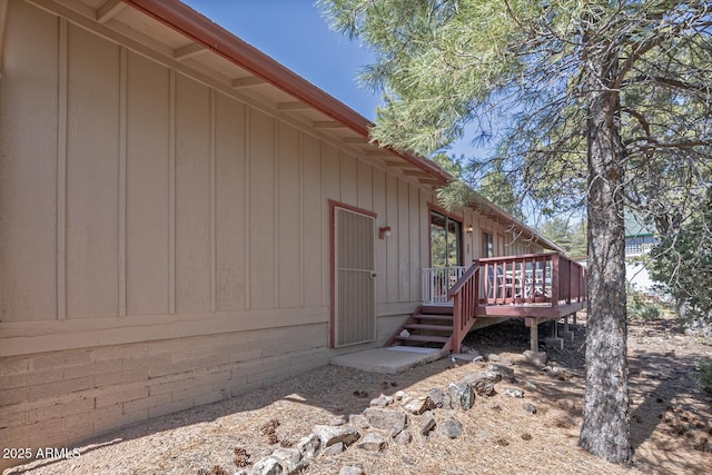 view of property exterior featuring a wooden deck