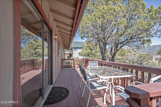 wooden terrace featuring outdoor dining space