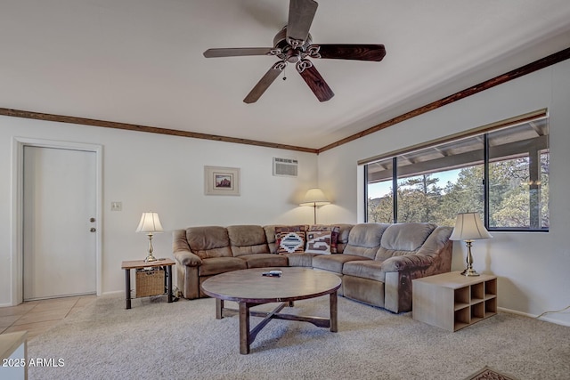 living area featuring light carpet, baseboards, crown molding, and ceiling fan