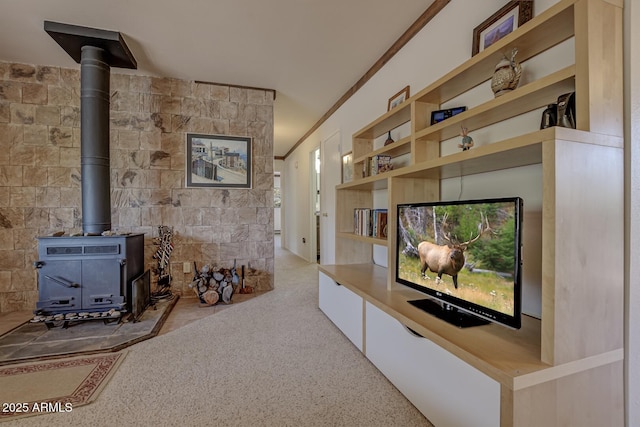 living area with carpet floors, a wood stove, and crown molding