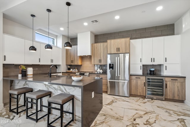 kitchen with wine cooler, sink, stainless steel fridge with ice dispenser, pendant lighting, and white cabinetry