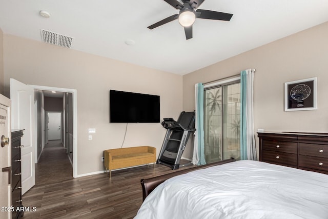 bedroom with visible vents, a ceiling fan, baseboards, and wood finished floors