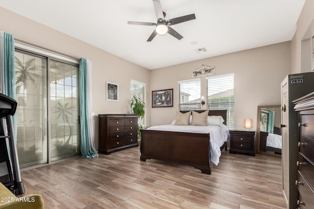 bedroom with light wood-style flooring, a ceiling fan, and visible vents