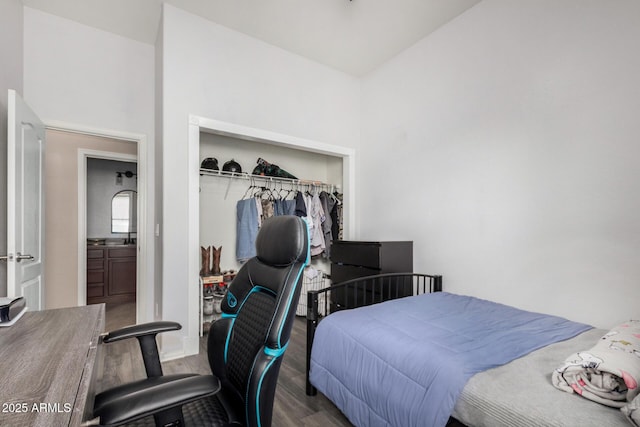 bedroom with wood finished floors and a closet