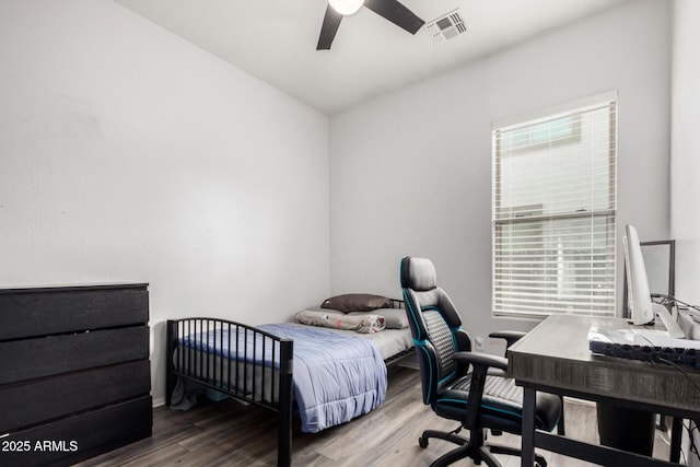 bedroom featuring visible vents, wood finished floors, and a ceiling fan