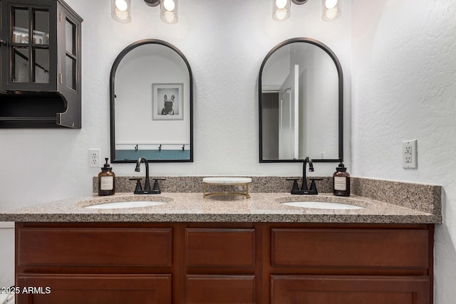 full bathroom featuring double vanity and a sink