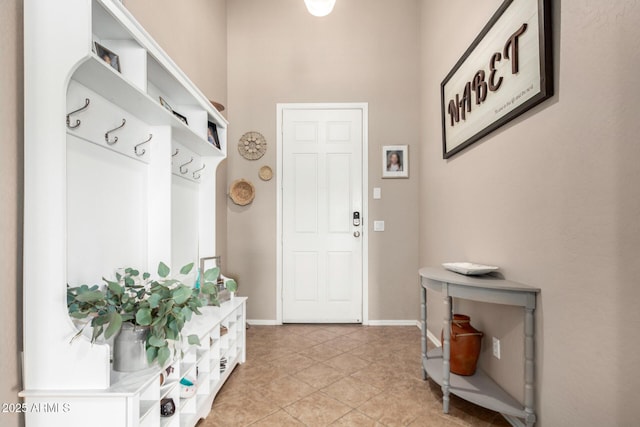 mudroom featuring baseboards and light tile patterned flooring