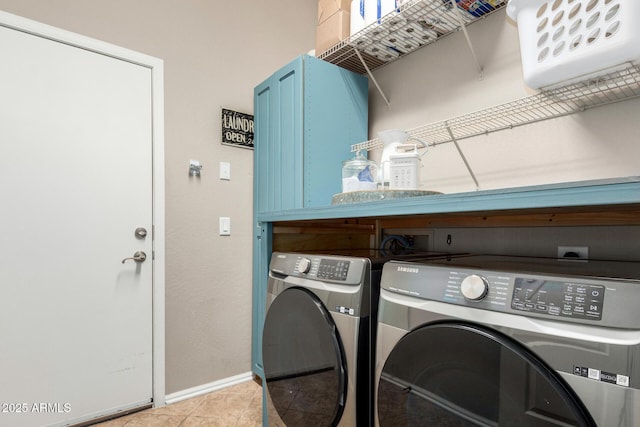 clothes washing area with light tile patterned floors, laundry area, baseboards, and separate washer and dryer