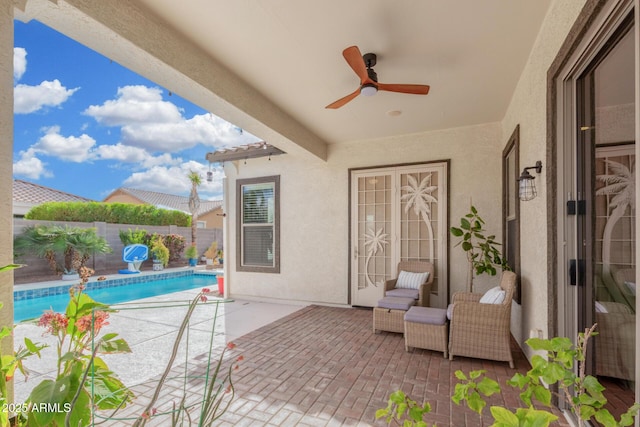 view of patio / terrace featuring a fenced in pool, ceiling fan, and fence