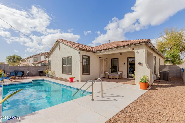 back of house with stucco siding, a patio, a fenced backyard, central AC unit, and ceiling fan