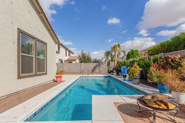 view of pool featuring a fenced in pool, a fenced backyard, and a patio area