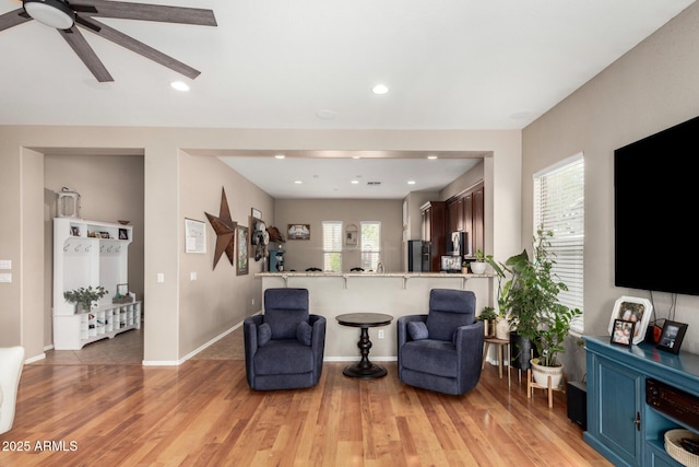 living area with recessed lighting, baseboards, light wood-style floors, and ceiling fan