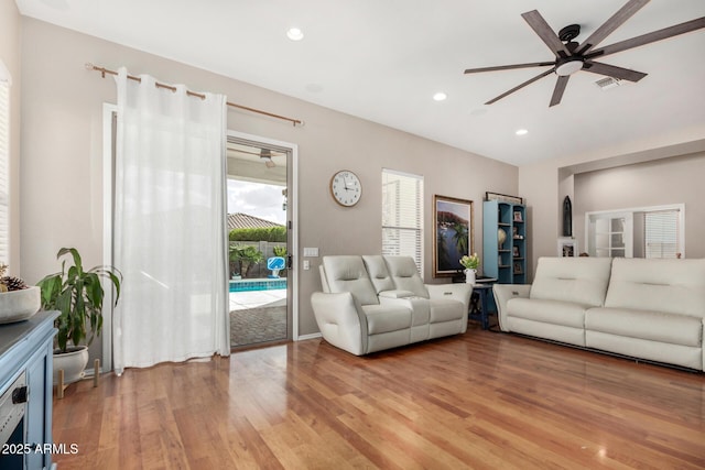 living room featuring a ceiling fan, visible vents, recessed lighting, and light wood-type flooring