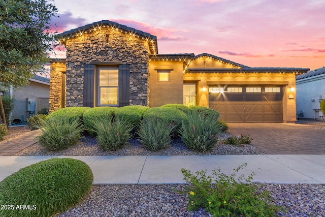 10650 E Palladium Dr, Mesa, AZ 85212 - view of front of house featuring a garage, driveway, stone siding, stucco siding, and a tile roof
