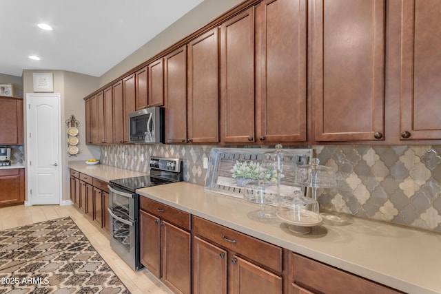10650 E Palladium Dr, Mesa, AZ 85212 - kitchen featuring stainless steel appliances, tasteful backsplash, light countertops, and recessed lighting