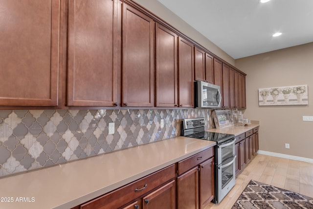 10650 E Palladium Dr, Mesa, AZ 85212 - kitchen featuring appliances with stainless steel finishes, recessed lighting, decorative backsplash, and light countertops