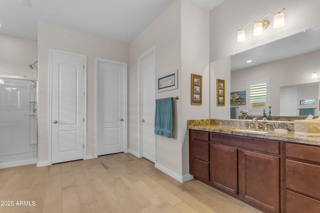 10650 E Palladium Dr, Mesa, AZ 85212 - bathroom featuring a shower stall, vanity, and wood finished floors