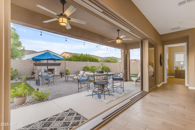10650 E Palladium Dr, Mesa, AZ 85212 - fenced backyard featuring outdoor dining space, ceiling fan, and a patio