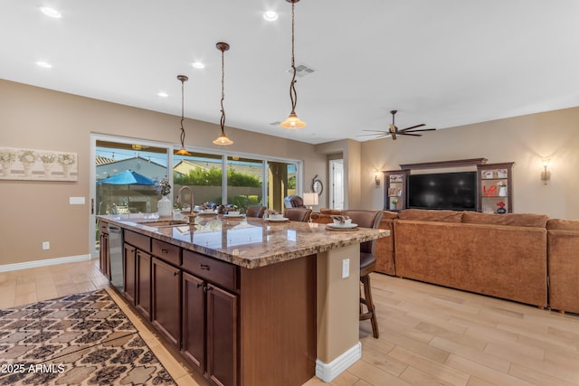 10650 E Palladium Dr, Mesa, AZ 85212 - kitchen with light wood-style flooring, open floor plan, a ceiling fan, light stone countertops, and recessed lighting