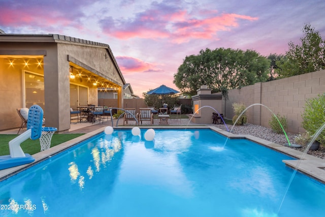 10650 E Palladium Dr, Mesa, AZ 85212 - pool at dusk featuring a fenced backyard, a patio area, and outdoor dining space