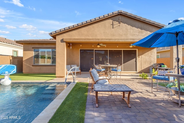 10650 E Palladium Dr, Mesa, AZ 85212 - rear view of house with stucco siding, a patio area, and outdoor dining space