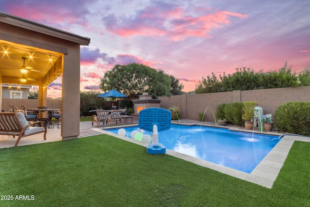 10650 E Palladium Dr, Mesa, AZ 85212 - pool at dusk featuring a fenced backyard and a patio