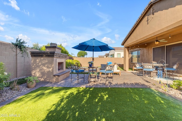 10650 E Palladium Dr, Mesa, AZ 85212 - fenced backyard with exterior fireplace, a patio, and a ceiling fan