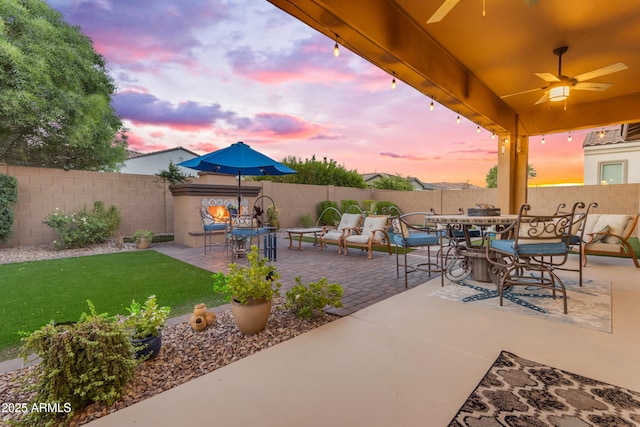 10650 E Palladium Dr, Mesa, AZ 85212 - fenced backyard with outdoor dining space, ceiling fan, and a patio area