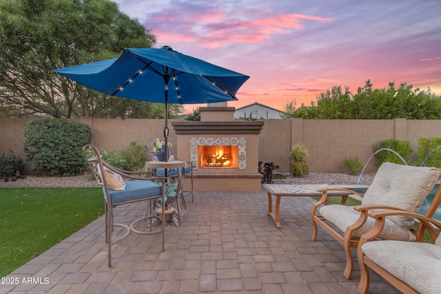 10650 E Palladium Dr, Mesa, AZ 85212 - fenced backyard with a lit fireplace and a patio area