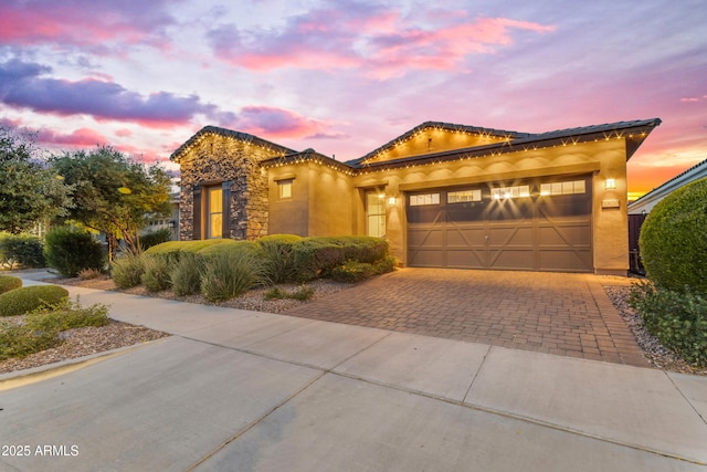 10650 E Palladium Dr, Mesa, AZ 85212 - mediterranean / spanish home with decorative driveway, stucco siding, and an attached garage
