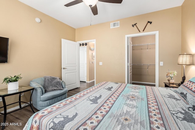 1941 S Pierpont Dr Unit 1099, Mesa, AZ 85206 - bedroom featuring wood finished floors, a walk in closet, ceiling fan, a closet, and baseboards