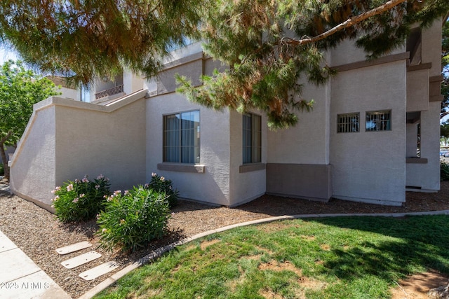 1941 S Pierpont Dr Unit 1099, Mesa, AZ 85206 - view of side of property featuring stucco siding and a yard
