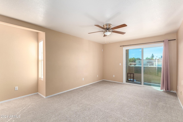 spare room featuring a textured ceiling, carpet flooring, and ceiling fan