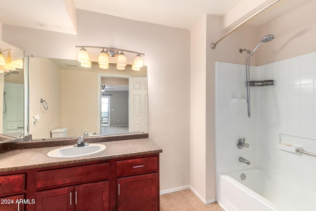 full bathroom featuring tile patterned floors, toilet, tiled shower / bath, vanity, and ceiling fan