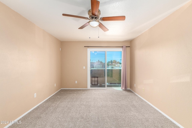 carpeted empty room featuring ceiling fan