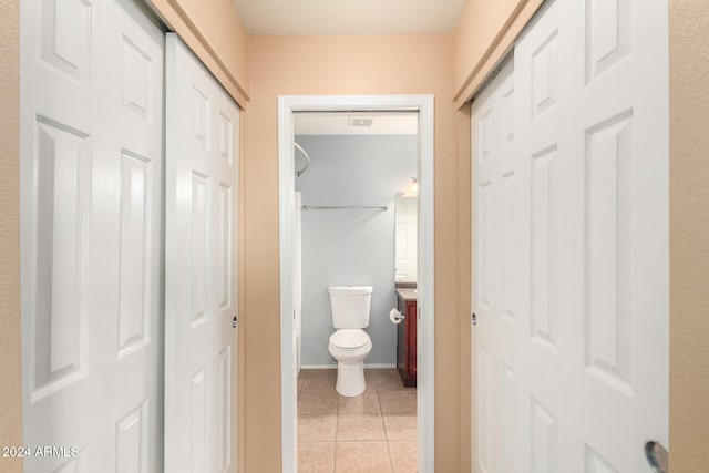 bathroom with vanity, toilet, and tile patterned flooring