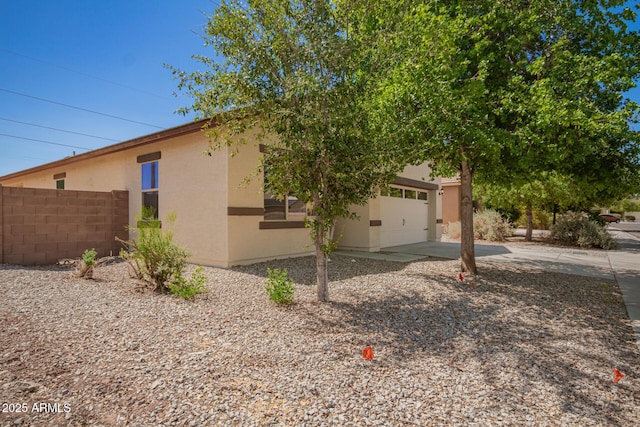 7324 S 254th Dr, Buckeye, AZ 85326 - view of property exterior featuring driveway, stucco siding, and an attached garage