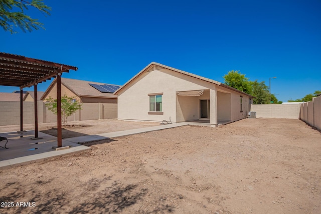 7324 S 254th Dr, Buckeye, AZ 85326 - rear view of house with stucco siding, a patio, a pergola, a fenced backyard, and a tiled roof