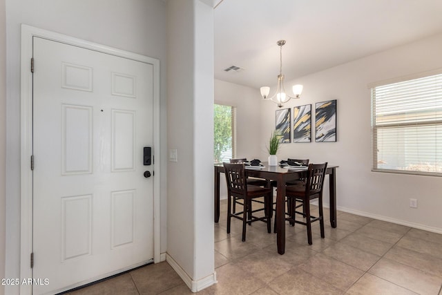 7324 S 254th Dr, Buckeye, AZ 85326 - dining room with a chandelier, baseboards, and light tile patterned floors