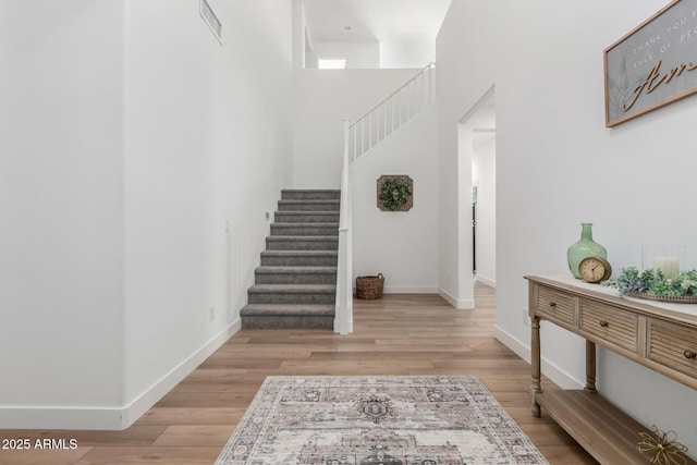 10956 E Thunderbolt Ave, Mesa, AZ 85212 - staircase with wood finished floors, baseboards, and a towering ceiling