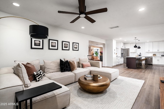 8341 E Hubbell St, Scottsdale, AZ 85257 - living area featuring a ceiling fan, recessed lighting, and light wood-style floors