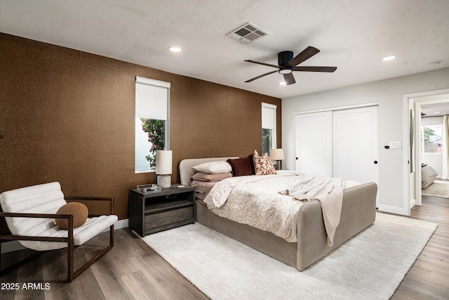 8341 E Hubbell St, Scottsdale, AZ 85257 - bedroom featuring wood finished floors, recessed lighting, a closet, baseboards, and a ceiling fan