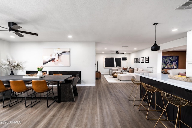8341 E Hubbell St, Scottsdale, AZ 85257 - dining space with a ceiling fan, dark wood finished floors, recessed lighting, a textured ceiling, and baseboards