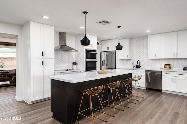8341 E Hubbell St, Scottsdale, AZ 85257 - kitchen featuring appliances with stainless steel finishes, wall chimney exhaust hood, decorative backsplash, a sink, and dark wood-type flooring