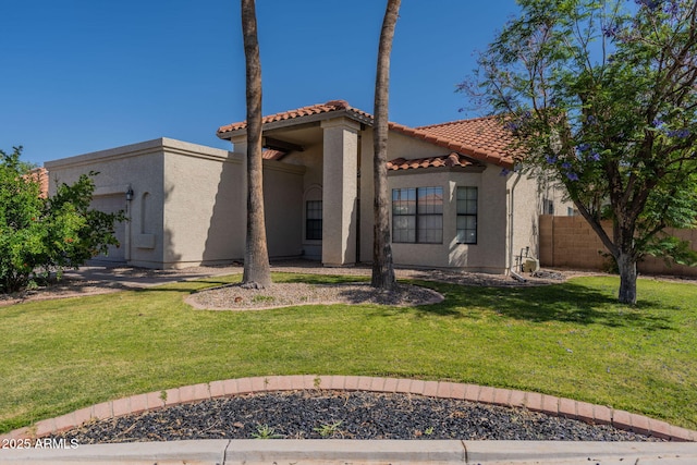 view of front facade featuring a front lawn, stucco siding, a tile roof, and fence
