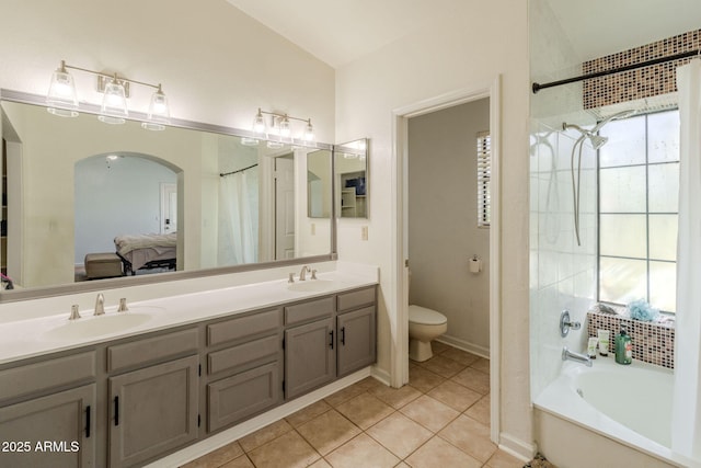 bathroom with toilet, tile patterned flooring, a sink, and a bath