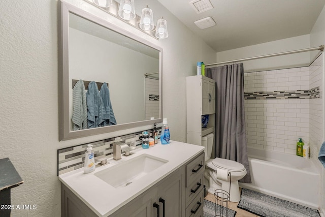 full bathroom featuring vanity, a textured wall, toilet, and visible vents