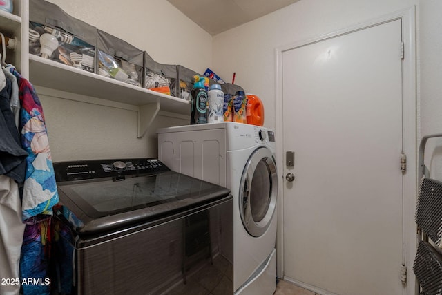 laundry area with laundry area and washer and clothes dryer