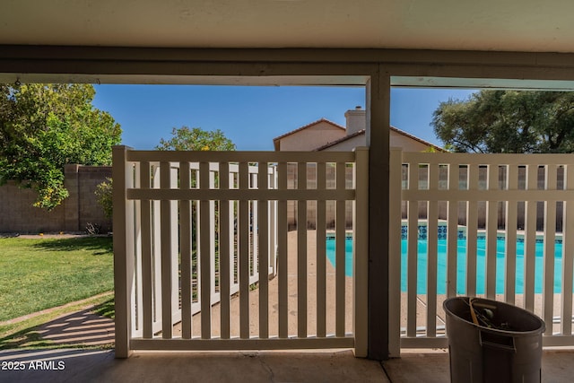 view of gate featuring fence and a fenced in pool